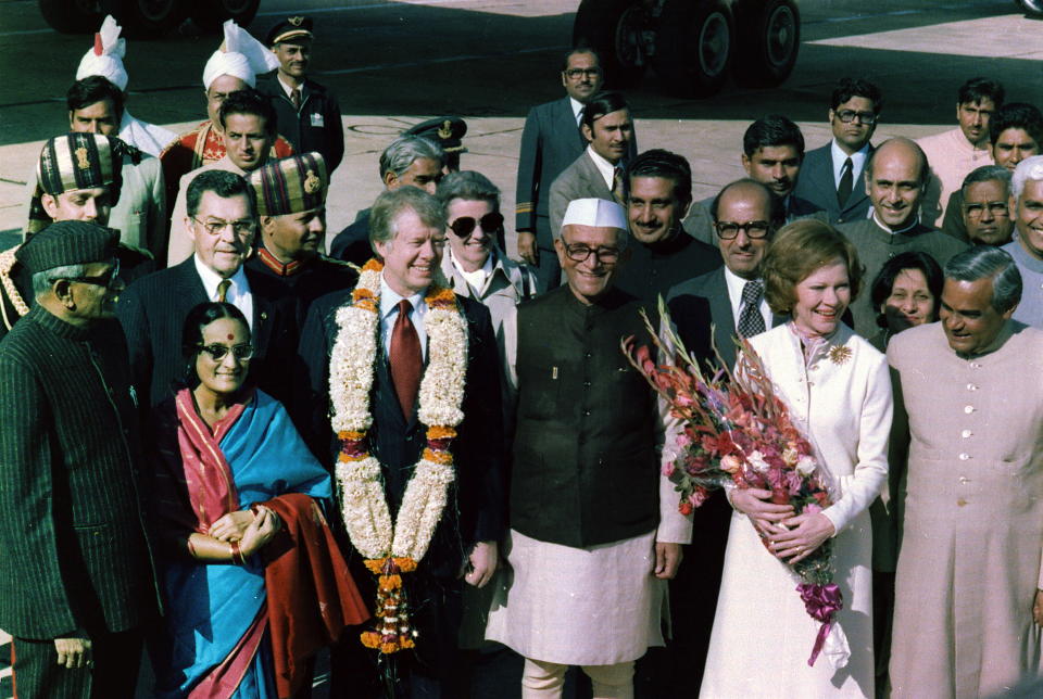 U.S. President Jimmy Carter is welcomed by Prime Minister Moraji Desai, standing with Rosalind Carter and future Indian Prime Minister Atal Bihari Vajpayee, during an arrival ceremony in New Delhi, India in January 1978. | Universal History Archive/Universal Images Group/Getty Images