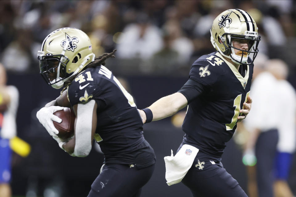 New Orleans Saints quarterback Andy Dalton (14) hands off the ball to running back Alvin Kamara (41) during the second half of an NFL football game against the Las Vegas Raiders Sunday, Oct. 30, 2022, in New Orleans. (AP Photo/Rusty Costanza)