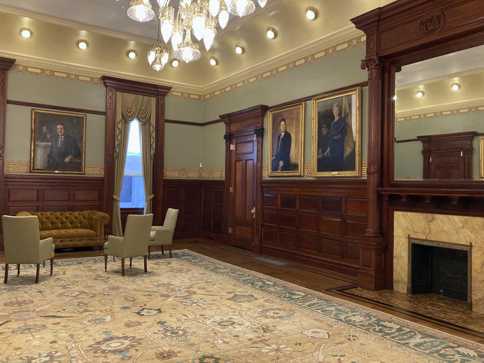 The renovated outer office of New Jersey's governor occupies the oldest part of the New Jersey statehouse, which dates to the 1700s, Wednesday, March 22, 2023, in Trenton, N.J. The building has been reopened and reoccupied by the governor's and other executive staff after a nearly six year $300-million renovation. The formerly gas-powered chandelier operates on LED lights now, a wall-to-wall carpet had been removed to reveal hardwood floors and the etching patterns on the walls was discovered beneath layers of paint. (AP Photo/Mike Catalini)