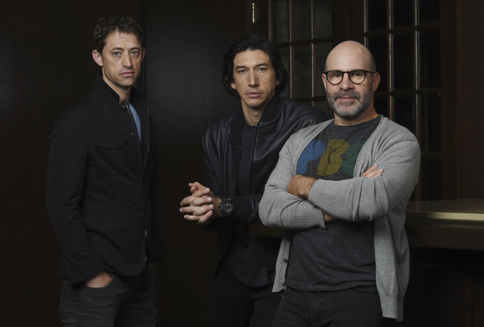 This Sept. 7, 2019 photo shows Scott Z. Burns, right, writer/director of "The Report," posing with former FBI investigator Daniel J. Jones, left, and actor Adam Driver at the Omni King Edward Hotel during the Toronto International Film Festival in Toronto. (Photo by Chris Pizzello/Invision/AP)