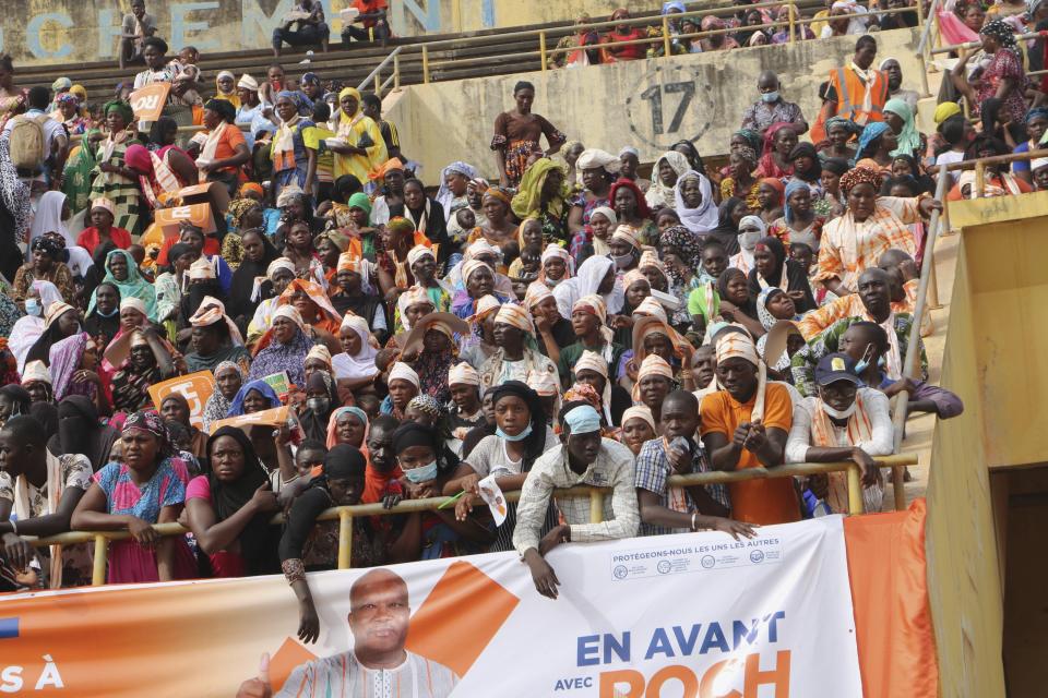 Supporters of Burkina Faso President Roch Kabore attend a campaign rally in Bobo-Dioulasso Thursday, Nov. 5, 2020. Burkina Faso will go to the polls on Nov. 22, 2020, to vote in presidential and legislative elections marred by ongoing violence. Attacks linked to Islamic militants have ravaged the once peaceful nation. (AP Photo/Sam Mednick)