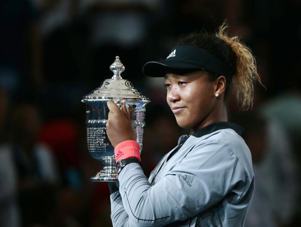 Naomi Osaka, of Japan, holds the trophy after defeating Serena Williams in the women's final of the U.S. Open tennis tournament, Saturday, Sept. 8, 2018, in New York. (AP Photo/Andres Kudacki)