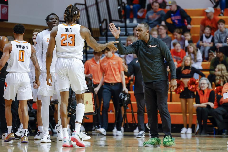 Oklahoma State coach Mike Boynton high fives forward Tyreek Smith during a timeout against Texas A&M-Corpus Christi on Tuesday at Gallagher-Iba Arena in Stillwater.