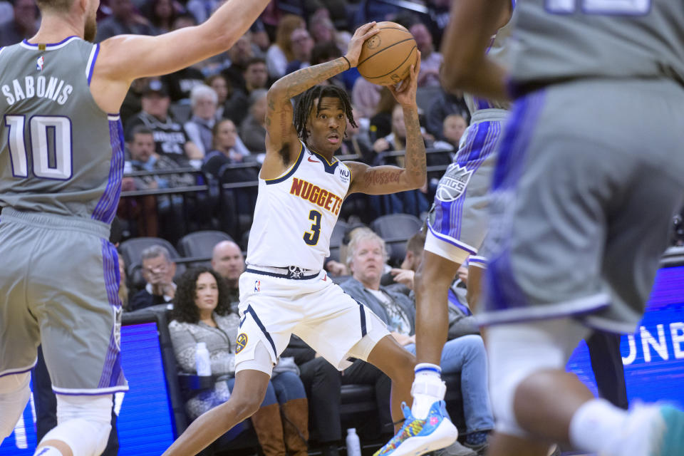 Denver Nuggets guard Bones Hyland (3) works the ball ball past Sacramento Kings defenders during the first quarter of an NBA basketball game in Sacramento, Calif., Wednesday, Dec. 28, 2022. (AP Photo/Randall Benton)