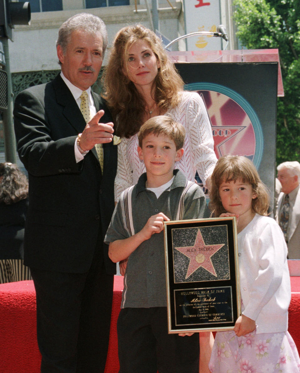 Game show host Alex Trebek, a native of Ontario, Canada poses with his family, wife Jean, son Matthew, 8 and daughter Emily,5, after his star on the Hollywood Walk of Fame was unveiled during ceremonies along Hollywood Boulevard May 17 in Hollywood. Trebek hosts the popular syndicated television game show 