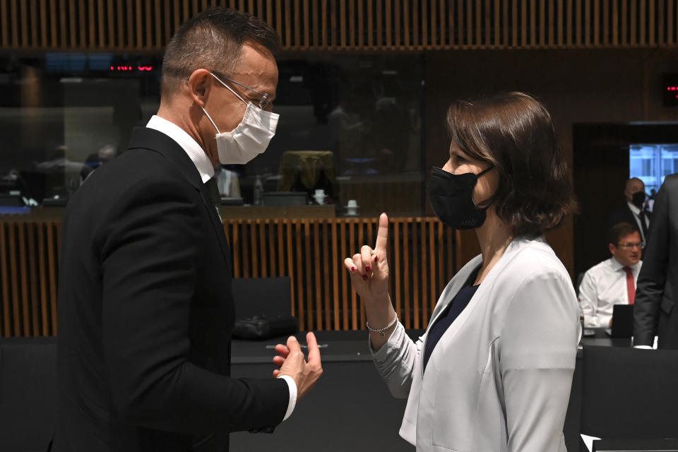 Hungarian Foreign Affairs and Trade Minister Peter Szijjarto, left, talks to Austrian European Affairs Minister Karoline Edtstadler during a European general affairs ministers meeting at the European Council building in Luxembourg, Tuesday, June 22, 2021. (John Thys/Pool Photo via AP)