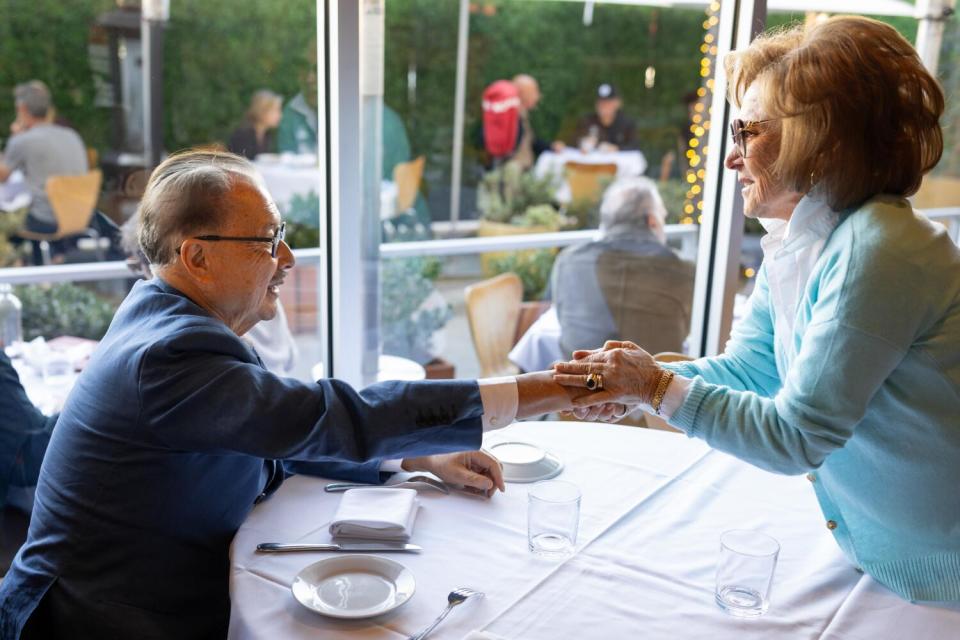 Mr. Chow shakes a fan's hand at E. Baldi Ristorante in Beverly Hills.