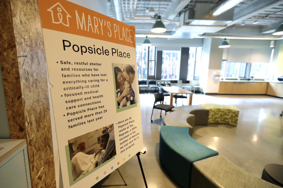 A sign outlines services offered by the Popsicle Place shelter program at Mary's Place, a family homeless shelter located inside an Amazon corporate building on the tech giant's Seattle campus, Wednesday, June 17, 2020. The Popsicle Place shelter program is an initiative to address the needs of homeless children with life-threatening health conditions. (AP Photo/Ted S. Warren)