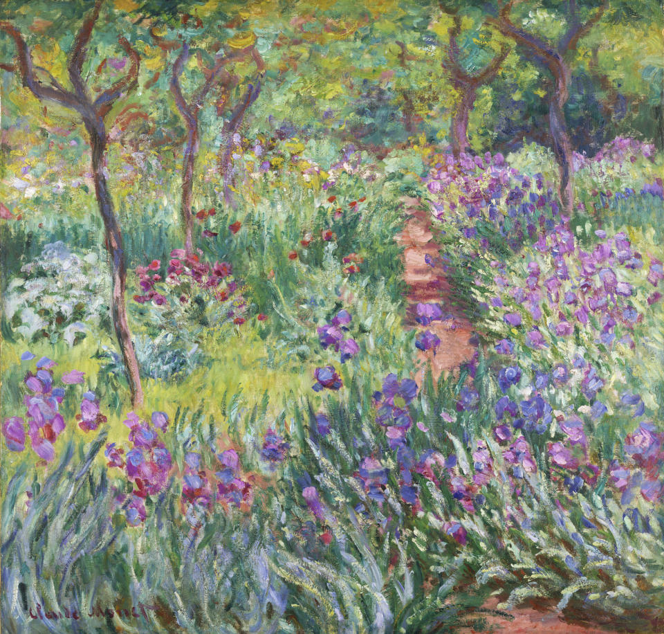 This undated photo provided by the New York Botanical Garden shows Claude Monet's painting, "The Artist's Garden in Giverny," which is on display in a new exhibition at the New York Botanical Garden, in New York. Monet once said he owed becoming a painter to his love for flowers and the exhibit explores the French impressionist artist’s passion for his beloved water lilies, irises and gardens and how they influenced his art. (AP Photo/New York Botanical Garden)