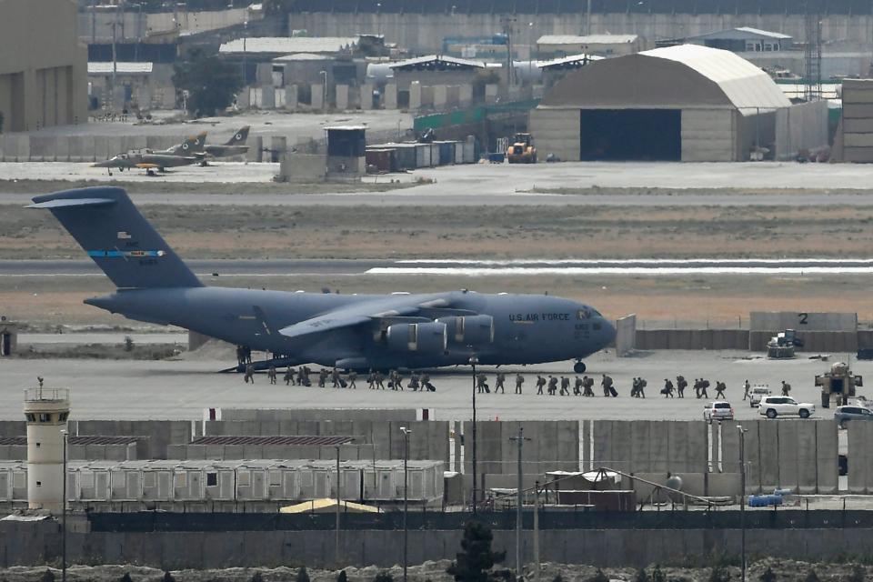 American soldiers board a U.S. Air Force aircraft at the airport in Kabul on Monday. 