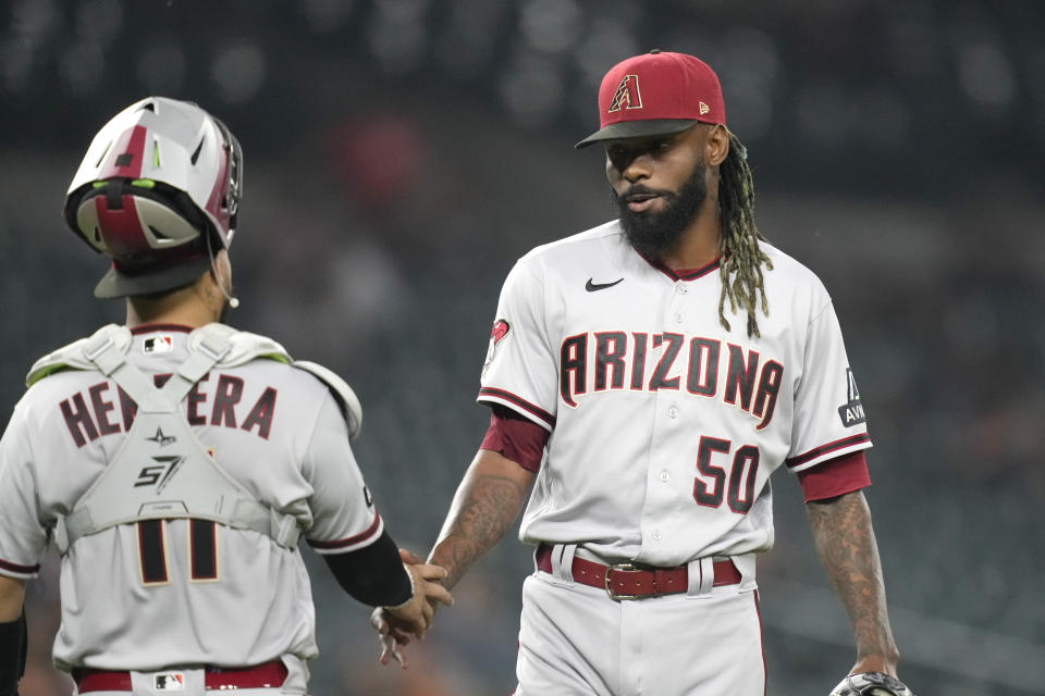 Arizona Diamondbacks relief pitcher Miguel Castro (50) shakes hands with catcher Jose Herrera (11) after the ninth inning of a baseball game against the Detroit Tigers, Friday, June 9, 2023, in Detroit. (AP Photo/Carlos Osorio)