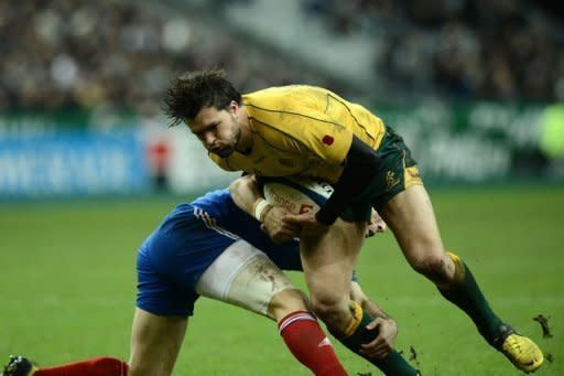 Australia's wing Adam Ashley-Cooper (R) is tackled by France scrum half Morgan Parra during the rugby union Test at the Stade de France. Australian coach Robbie Deans was left shell-shocked after seeing his team convincingly put to the sword 33-6