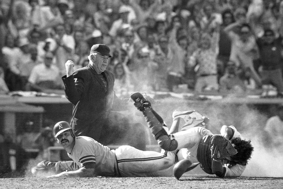 FILE - Umpire Tom Gorman signals out after Oakland Athletic's Sal Bando, left, collided with Los Angeles Dodgers catcher Steve Yeager at home plate during a baseball game in Los Angeles on Oct. 12, 1973. Bando, a three-time World Series champion with the Oakland Athletics and former Milwaukee Brewers executive, died Friday night, Jan. 20, 2023, in Oconomowoc, Wis., according to a statement from his family. He was 78. (AP Photo/File)