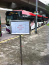 A sign indicating that shuttle buses were available between affected stations was placed at a bus stop outside Harbourfront station. (Yahoo! photo/Lin Wenjian)