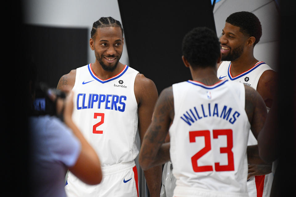 PLAYA VISTA, CA - SEPTEMBER 29:  Los Angeles Clippers Forward Kawhi Leonard (2), Los Angeles Clippers Forward Paul George (13) and Los Angeles Clippers Guard Lou Williams (23) pose for a photo during media day at the Los Angeles Clippers Training Center on September 29, 2019 in Playa Vista, California. (Photo by Brian Rothmuller/Icon Sportswire via Getty Images)
