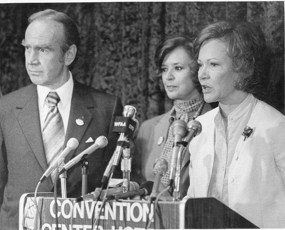 First lady Mrs. Rosalynn Carter visits Fort Worth in 1980, speaking at a convention podium to the public and press. Besides her are House Majority Leader Jim Wright of Fort Worth and his wife, Betty Wright. Contributed