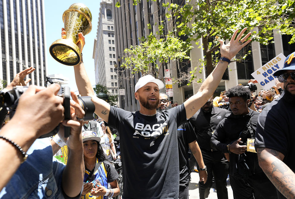 SAN FRANCISCO, CALIFORNIA - JUNE 20: Stephen Curry #30 of the Golden State Warriors celebrates with his NBA Finals Most Valuable Player Award during the Golden State Warriors Victory Parade on June 20, 2022 in San Francisco, California. The Golden State Warriors beat the Boston Celtics 4-2 to win the 2022 NBA Finals. NOTE TO USER: User expressly acknowledges and agrees that, by downloading and or using this photograph, User is consenting to the terms and conditions of the Getty Images License Agreement. (Photo by Thearon W. Henderson/Getty Images)