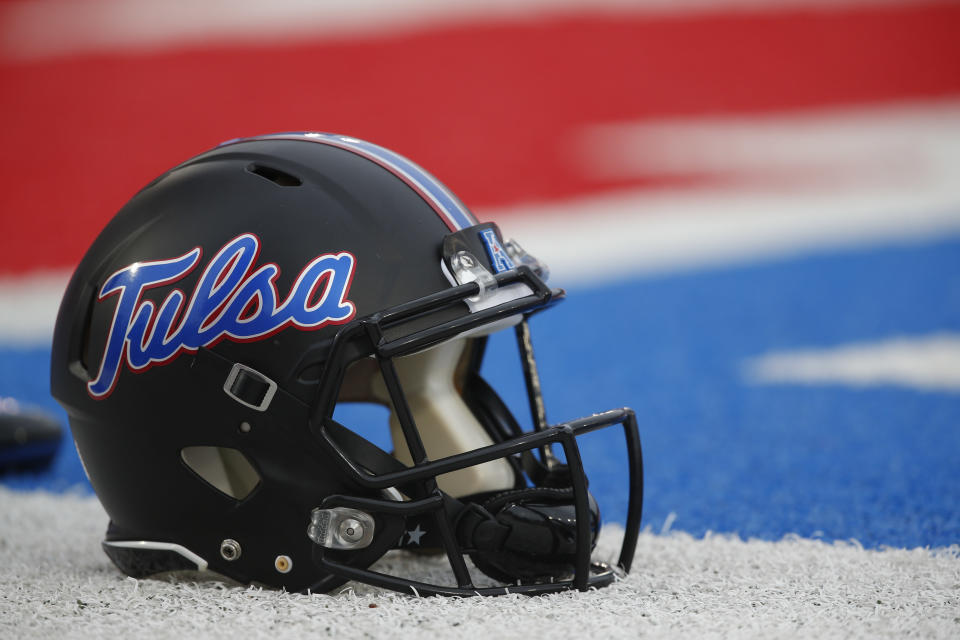 An Tulsa football helmet sits on the sideline before an NCAA football game against SMU, Saturday, Oct. 31, 2015, in Dallas. (AP Photo/Jim Cowsert)