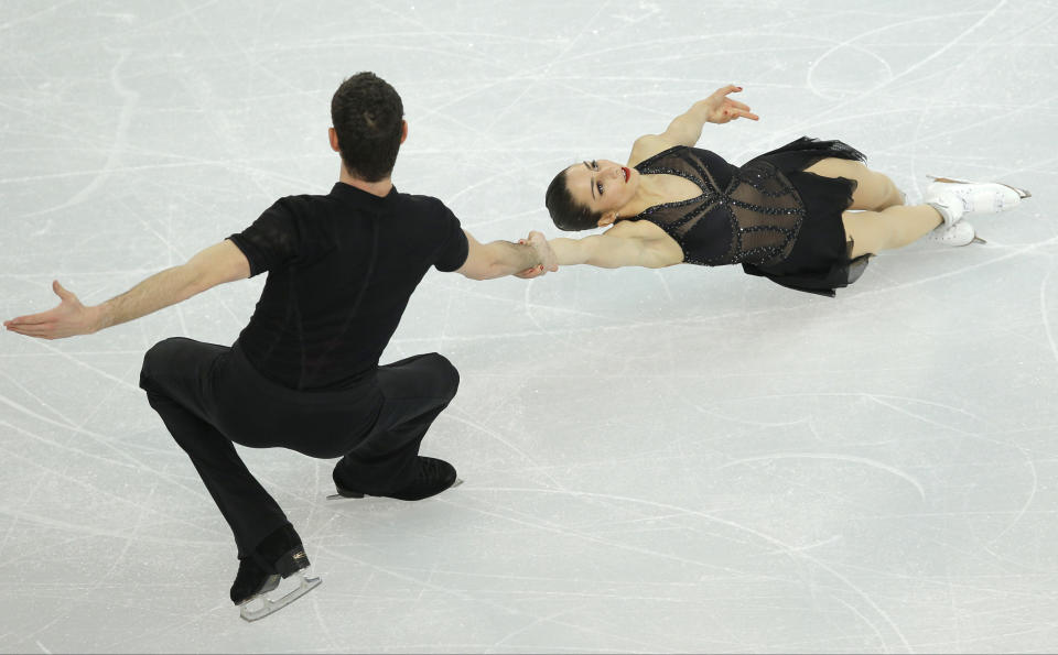 Marissa Castelli and Simon Shnapir of the United States compete in the team pairs short program figure skating competition at the Iceberg Skating Palace during the 2014 Winter Olympics, Thursday, Feb. 6, 2014, in Sochi, Russia. (AP Photo/Vadim Ghirda)