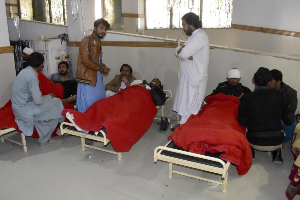Injured victims of a suicide bombing are treated at a hospital in Quetta, Pakistan, Wednesday, Nov. 30, 2022. A suicide bomber blew himself up near a truck carrying police officers on their way to protect polio workers outside Quetta officials said. (AP Photo/Arshad Butt)