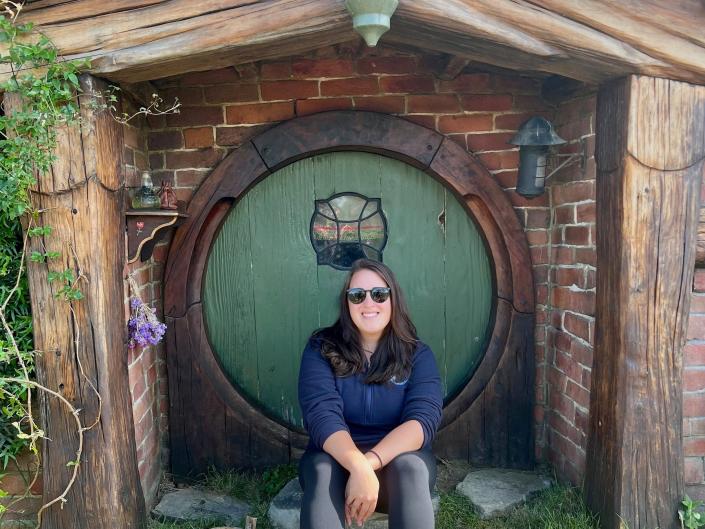 Sitting in front of a Hobbit home at the movie set in New Zealand.