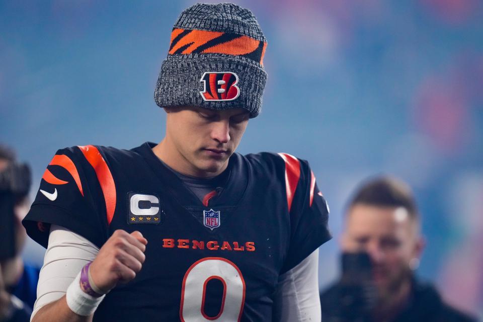 Cincinnati Bengals quarterback Joe Burrow pumps his fist as he walks for the locker room