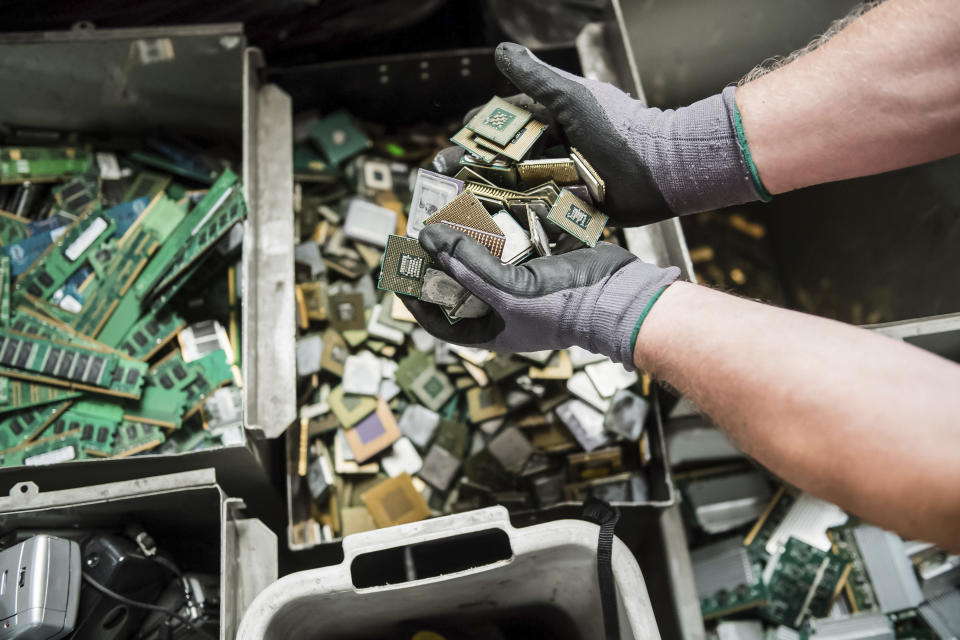 In this photo taken on July 13, 2018, a worker handles components of electronic elements at the Out Of Use company warehouse in Beringen, Belgium. Out Of Use dismantles computer, office and other equipment and recuperates an average of around 90 percent of the raw materials from electronic waste. (AP Photo/Geert Vanden Wijngaert)