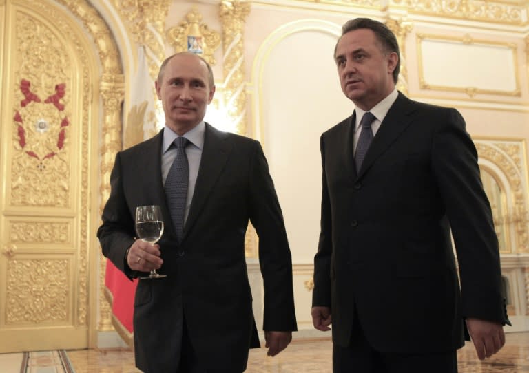 Russia's President Vladimir Putin (L) and Sports Minister Vitaly Mutko attend a farewell ceremony for members of the Olympic team at the Kremlin, prior to their departure for the Olympic Games in London, on July 21, 2012