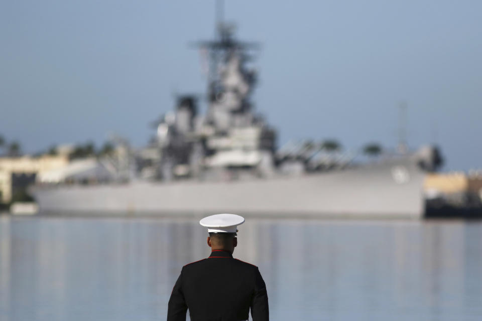 FILE - In this Dec. 7, 2019, file photo, a U.S. Marine stands in front of the USS Missouri during a ceremony to mark the 78th anniversary of the Japanese attack, in Pearl Harbor, Hawaii. Some veterans and government officials will gather on the Missouri on Wednesday, Sept. 2, 2020, in Hawaii to mark the 75th anniversary of the surrender. (AP Photo/Caleb Jones, File)