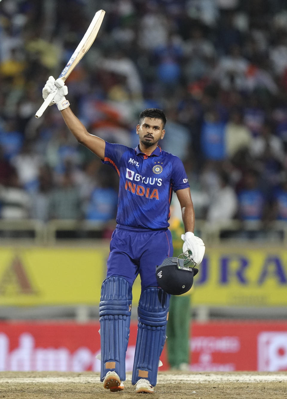 India's Shreyas Iyer raises his bat to celebrate his century during the second one day international cricket match between India and South Africa, in Ranchi , India, Sunday, Oct. 9, 2022. (AP Photo/Mahesh Kumar A.)