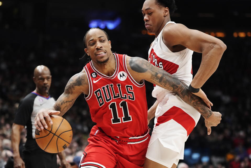 Chicago Bulls forward DeMar DeRozan (11) drives past Toronto Raptors forward Scottie Barnes during the first half of an NBA basketball game Tuesday, Feb. 28, 2023, in Toronto. (Frank Gunn/The Canadian Press via AP)