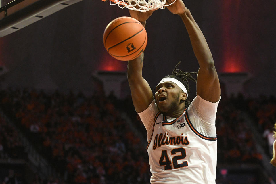 Illinois' Dain Dainja (42) dunks during the first half of an NCAA college basketball game against Rutgers, Saturday, Feb. 11, 2023, in Champaign, Ill. (AP Photo/Michael Allio)