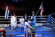 Cuban and U.S. boxers greet each other before the start of competition in Havana, Cuba, Friday, April. 4, 2014. Boxers from the U.S. and Cuba went glove-to-glove on Cuban soil for the first time in 27 years Friday in a semipro World Series of Boxing clash. (AP Photo/Ramon Espinosa)