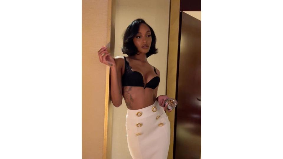 Jourdann Dunn in a black bra and cream skirt