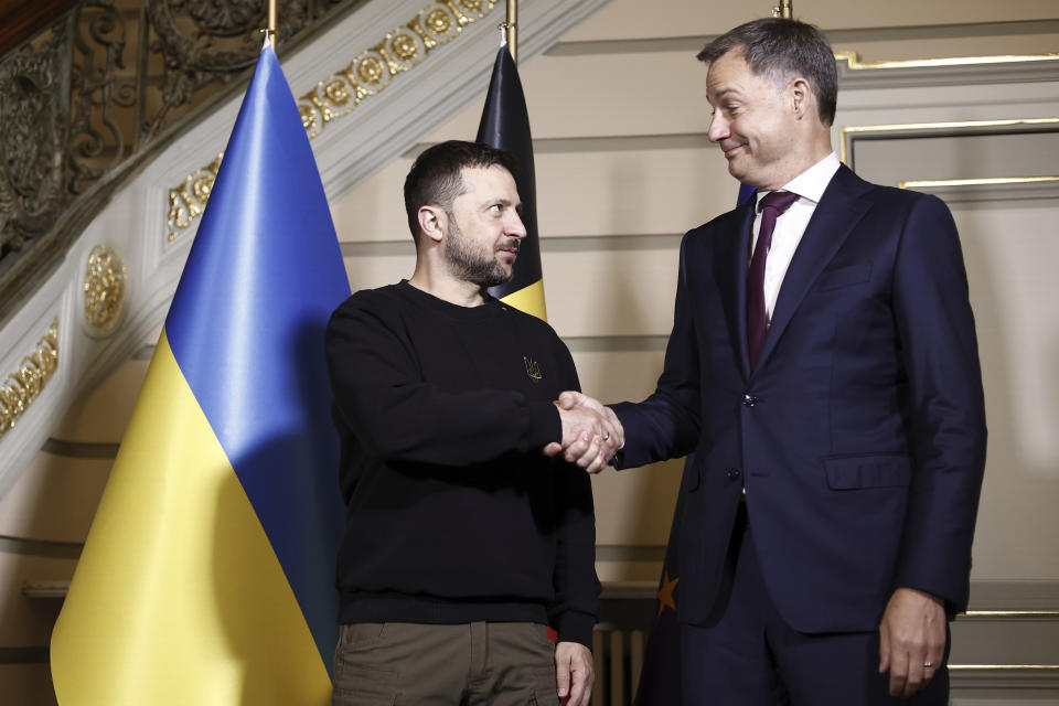 Ukraine's President Volodymyr Zelenskyy, left, shakes hands with Belgium's Prime Minister Alexander De Croo during their meeting at the prime ministers' office in Brussels, Tuesday, May 28, 2024. (Kenzo Tribouillard/Pool Photo via AP)