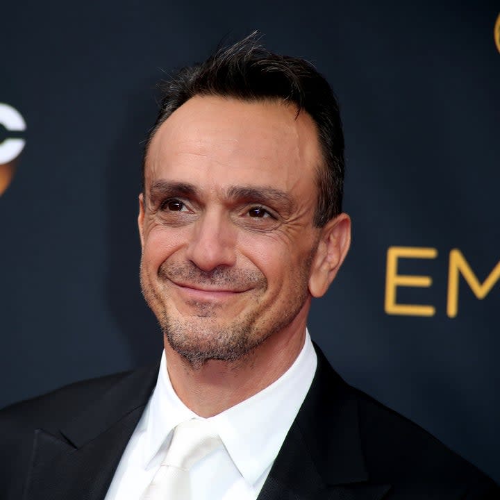 Hank Azaria smiling on the red carpet at the Emmy Awards