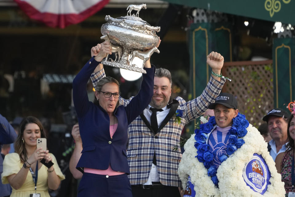 Trainer Jena Antonucci, left, hoists up the August Belmont Trophy alongside jockey Javier Castellano, right, and owner Jon Ebbert, center, after their horse Arcangelo won the 155th running of the Belmont Stakes horse race, Saturday, June 10, 2023, at Belmont Park in Elmont, N.Y. (AP Photo/Seth Wenig)