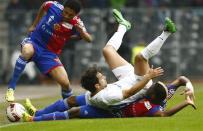 FC Basel's Geoffroy Serey Die (bottom) tackles FC Zurich's David Chiumiento (C) during their Swiss Cup final soccer match in the Stade de Suisse stadium in Bern April 21, 2014. REUTERS/Ruben Sprich