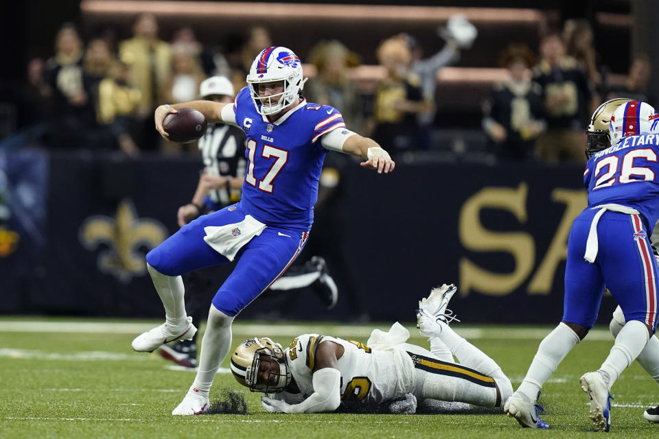 Buffalo Bills quarterback Josh Allen (17) carries against New Orleans Saints cornerback P.J. Williams in the second half of an NFL football game in New Orleans, Thursday, Nov. 25, 2021. (AP Photo/Derick Hingle)