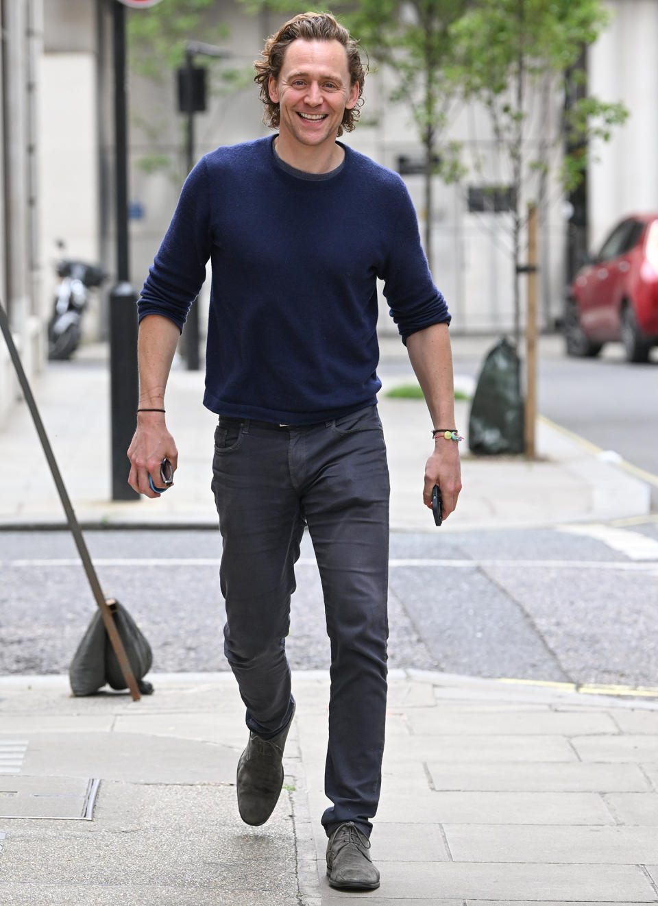 <p>Tom Hiddleston cracks a smile as he leaves BBC Radio 2 Studios in London on May 11. </p>