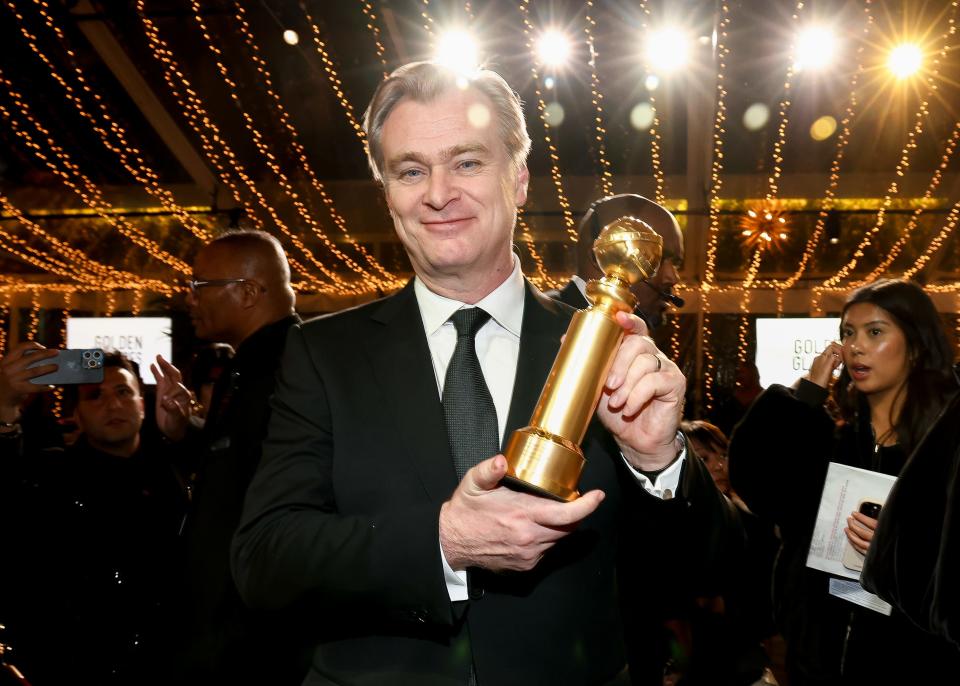 Christopher Nolan holding Golden Globe