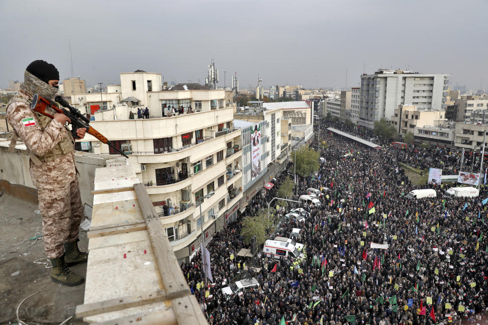 FILE - In this Nov. 25, 2019, file photo, an Iranian soldier stands guard overlooking a pro-government rally organized by authorities in Tehran, Iran, denouncing violent protests over a government-imposed fuel price hike. Even among hard-liners in Iran, there seems to be an acknowledgment of one fact after widespread protests, violence and a security force crackdown following government-set gasoline prices spiking: This will not be the last time demonstrators come out on the street. (AP Photo/Ebrahim Noroozi, File)