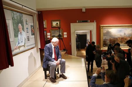 David Attenborough poses next to a portrait of himself by Bryan Organ to mark his 90th birthday at New Walk Museum and Art Gallery in Leicester, Britain, September 22, 2016. REUTERS/Darren Staples