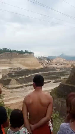 People are seen in an area after a landslide in the City of Naga, Cebu, Philippines September 20, 2018, in this still image taken from a social media video. SAM MOCHA UY/via REUTERS