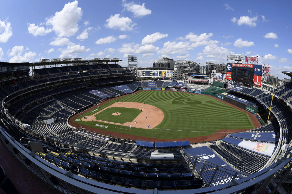 In this photograph taken with a fisheye lens, the Washington Nationals and the Miami Marlins compete during the fourth inning of a baseball game, Sunday, Aug. 23, 2020, in Washington. (AP Photo/Nick Wass)