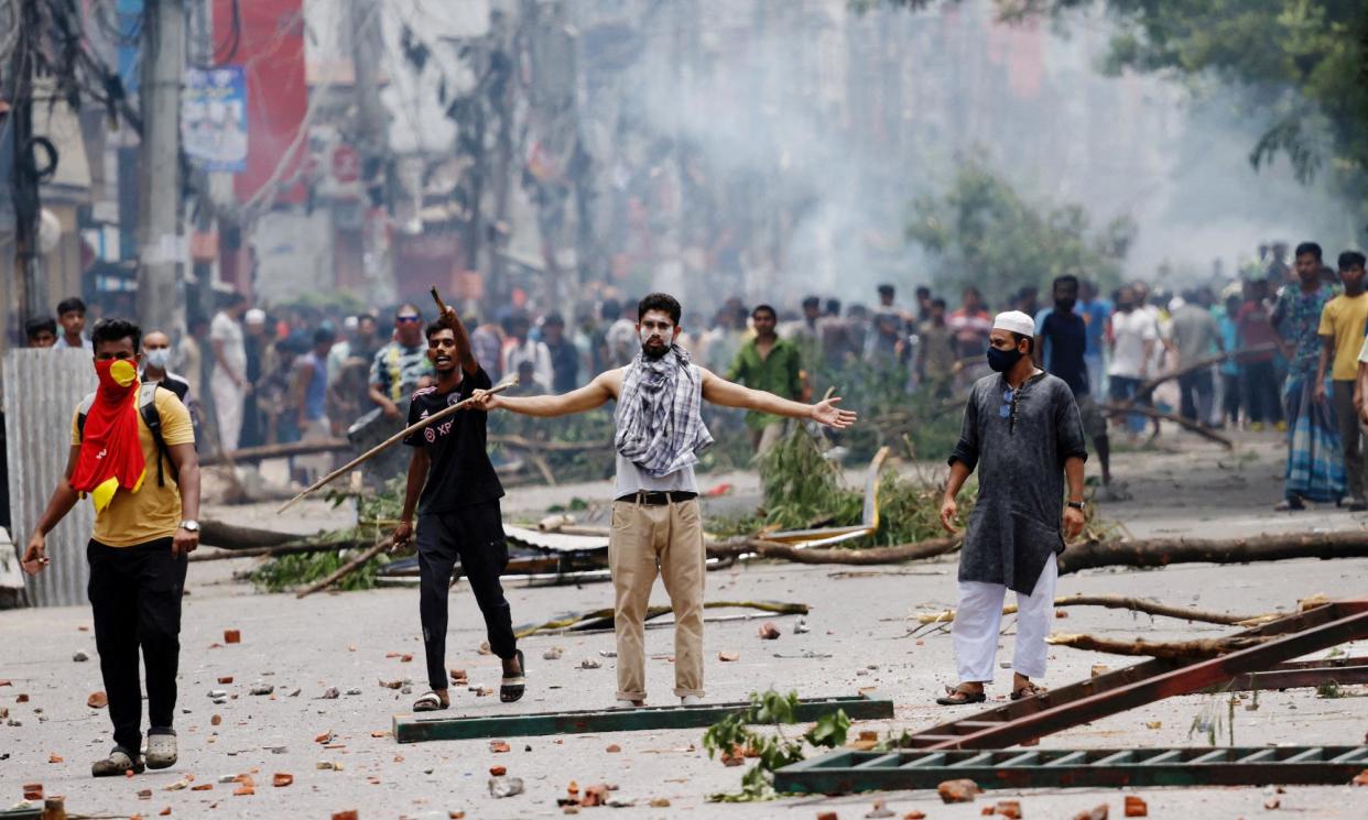 <span>Protesters clash with guards and police as violence erupts across Bangladesh after anti-quota protests by students in Dhaka.</span><span>Photograph: Mohammad Ponir Hossain/Reuters</span>