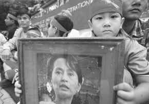 A young supporter of democracy for Myanmar, also called Burma, displays a portrait of Aung San Suu Kyi Saturday outside the Myanmar embassy in Bangkok, Thailand. AP PHOTO