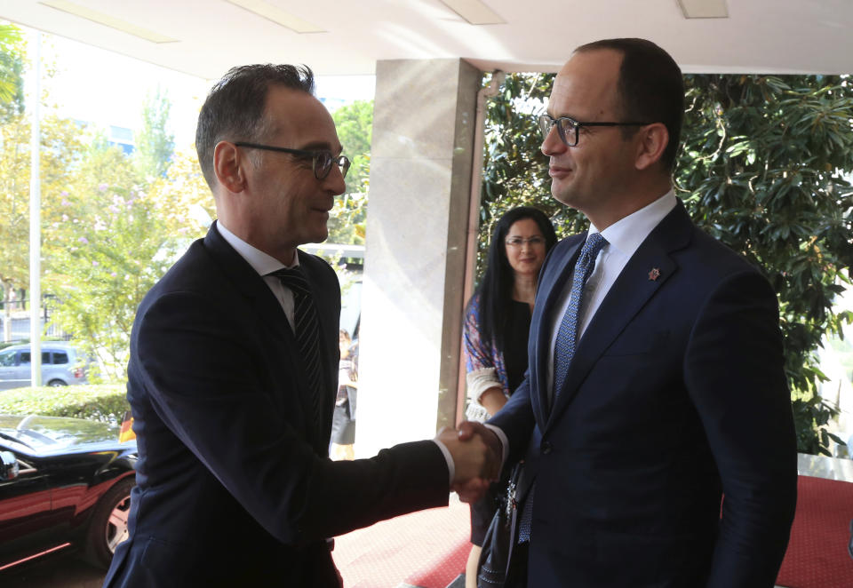 Albanian Foreign Minister Ditmir Bushati, right, welcomes, his German counterpart Heiko Maas during their meeting in Tirana, Wednesday, Sept. 19, 2018. (AP Photo/Hektor Pustina)