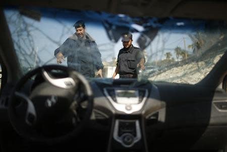 Hamas naval police inspect parts of a car which they said was seized from two Palestinians who tried to smuggle it from Egypt by sea into Gaza City November 11, 2013. REUTERS/Mohammed Salem