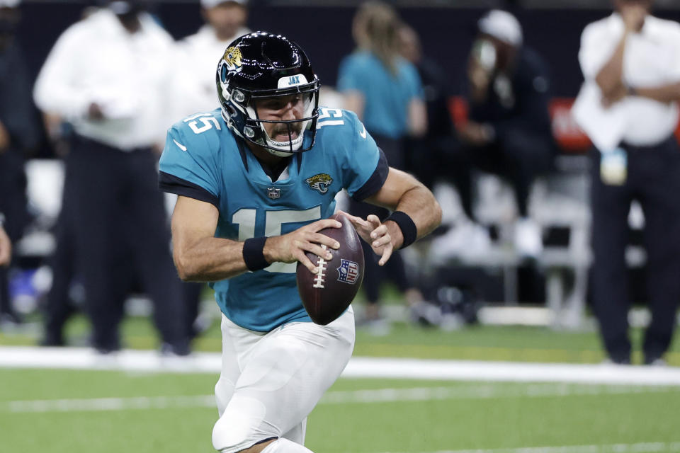 Jacksonville Jaguars quarterback Gardner Minshew (15) scrambles in the second half of an NFL preseason football game against the New Orleans Saints in New Orleans, Monday, Aug. 23, 2021. (AP Photo/Derick Hingle)